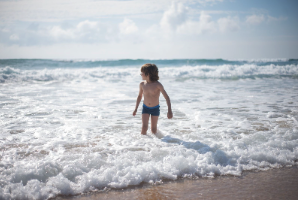 Child wading in the ocean