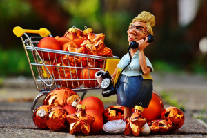 Senior on the phone surrounded by pumpkins in a shopping cart